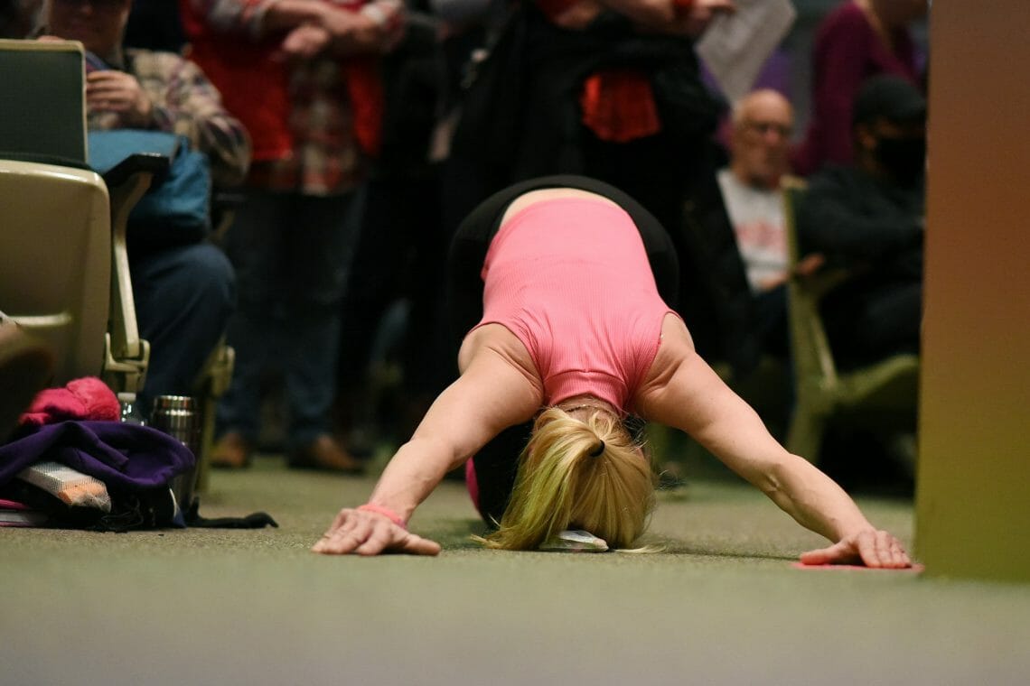 A woman does push-ups during audience testimony